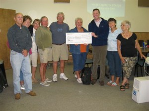 Six Mile lake Association presents the first moneys to the Little Traverse Conservancy 
